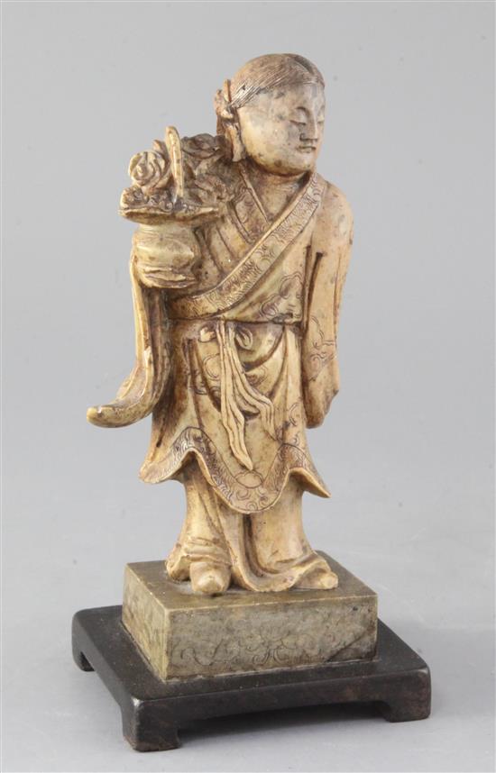 A Chinese creamy soapstone figure of He Xiangu, 19th century, 23cm high